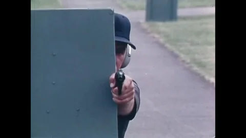 1974 - An instructor teaches basic shooting techniques, including firing a Video stock 126049178