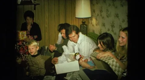 1974: large family gathered around opening christmas gifts FORT WAYNE, INDIANA Stock Footage