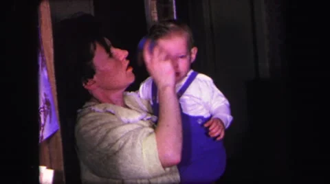 1974: a woman brushes the hair of a toddler in overalls LYNBROOK, NEW YORK Stock Footage