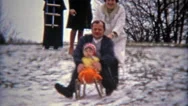 1975: Family Dangerously Winter Snow Sledding With Young Son. Stock Footage