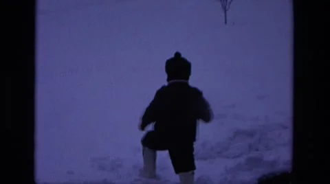 1975: two toddlers play in the snow on their front yard CALIFORNIA Stock Footage