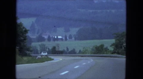 1976: countryside motorist views hills trees and valleys while driving Stock Footage