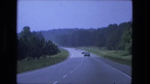 1976: highway driving out of town into green forest rural area FORT WAYNE Stock Footage