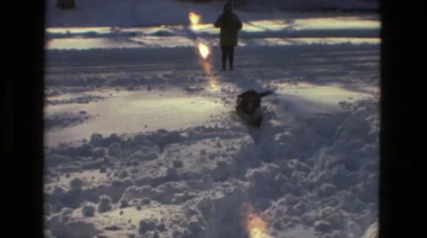 1978: dog trying to walk in the snow with boy LAS VEGAS Stock Footage