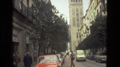 1978: lady walking in front of historic buildings in the middle of the street Stock Footage