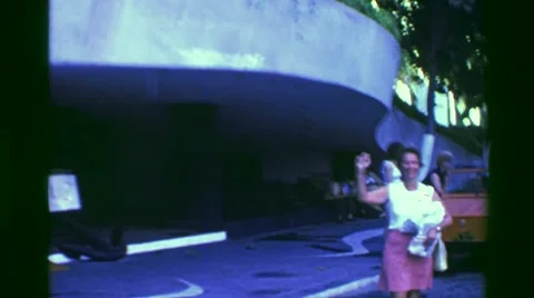1978: Marriott hotel skyscraper tower guest waves goodbye lobby entrance. Stock Footage 63994459
