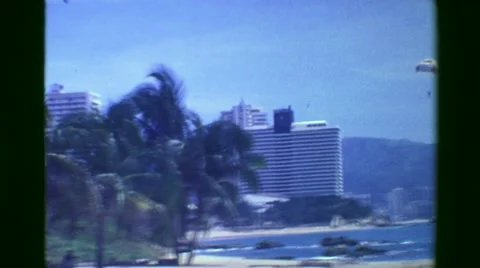 1978: Skyscraper Resort Beach Hotels Parasailing Tropical Paradise Tourism. Stock Footage 63994174
