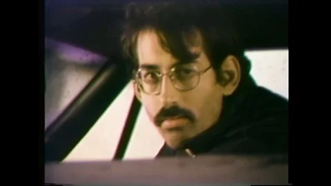 1979 - A man is arrested for trying to commit currency fraud in a bank. Video stock 101610788