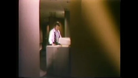 1979 - A man uses a copy machine to make counterfeit money. Stock Footage 101610830