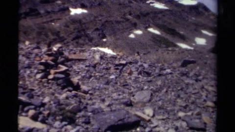 1979: Stacked Rock Rubble at the Base of a Snow-Dusted Hill in British Columbia Stock Footage 70653038