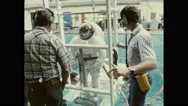 1980S: Astronaut In Space Suit Is Lowered Into Water. City. Stock Footage