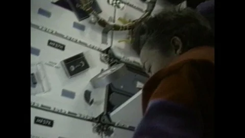 1980s: astronaut working in mechanical panel adjusting screws and knobs with a 스톡 동영상 109224988