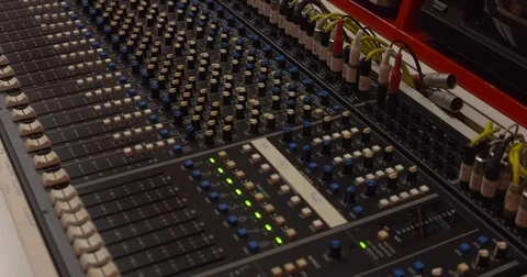 1980s audio console, 18-channel analog mixing console, adjusting faders Stock Footage 72917074