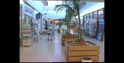 1980s Australian Shopping Mall With Shoppers And Escalators Stock Footage 318823984