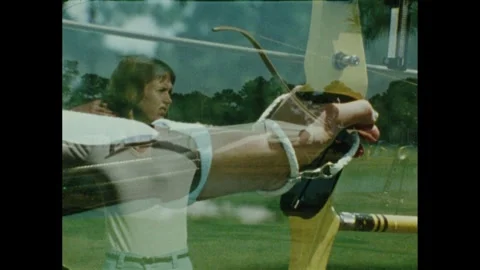 1980s: Bow raised in the hand using the high wrist hold, arrow pulled back. Stock Footage 296505489