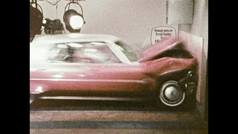1980s: Car slams into barricade on vehicle test track. Crash test dummies lie in Stock Footage