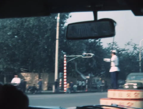 1980s CHINA | EXPLORING BEIJING BY CAR, PASSING TRAFFIC POLICEMAN (1983) Stock Footage 287920767