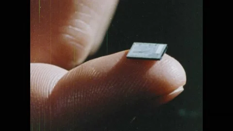 1980s: Computer.  Microchip on finger.  Scientists talk in lab.  Machine bottles Stock Footage 168386162