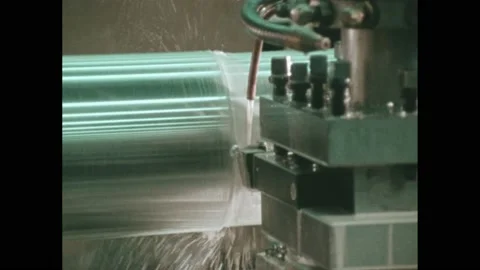 1980s: Computer readout. Cutting fluid flows onto a lathe. Punched paper tape. Video stock 205309889