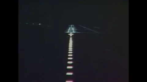 1980s: Computerized airplane landing display. A man looks at the display and Video stock 84904071
