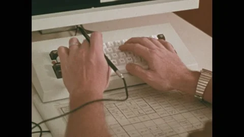 1980s: Hands type on computer keyboard. Kaleidoscope view of hands typing. Men Stock Footage 205309913