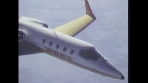 1980s: Jet plane flies through air. Jet plane goes in for landing. Stock Footage 84738082