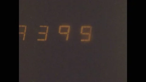 1980s: Machine sorts checks. Numbers. Man picks up checks. Computer prints bank Stock Footage 159986132