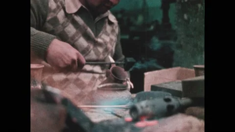 1980s: man engraves pattern on copper with hammer and engraving tool, men use Stock Footage 236924209