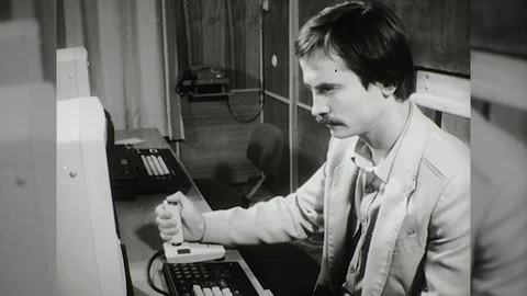 1980s Man Plays Computer Game Joystick Desktop PC Vintage Old Film Movie Vidéo 87297080