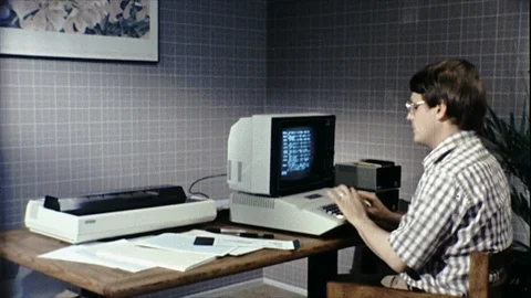 1980s Man at Workstation Personal Computer Printing Out Vintage Old Film Movie Stock Footage