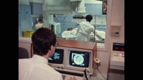 1980s: operating room w/surgical instruments, doctor looks at computer while Stock Footage 145214651