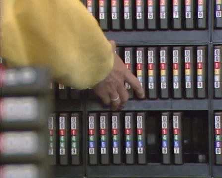 1980s: Operator takes a magnetic computer tape from shelf. Vidéo 46703559