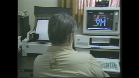 1980s: person sitting at computer, Intel terminal, various equipment alongside Stock Footage 129852992