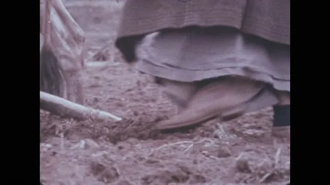 1980s: Plow moving through soil. Low angle of oil rig. Cars driving at night. Stock Footage 219817848
