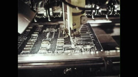 1980s: Robots in computer factory attach microprocessors to circuit boards. Stock Footage 226411945
