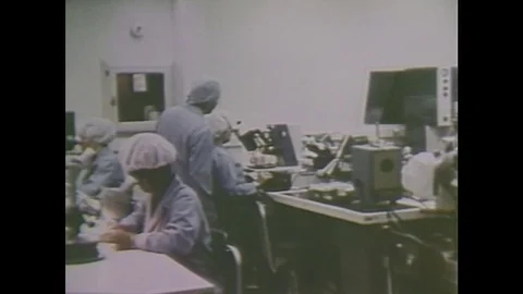 1980s: Scientists work in lab at microscopes. Man works at computer. Stock Footage 84615487
