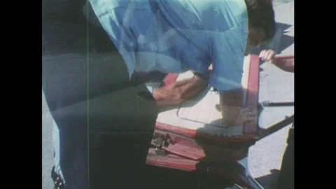 1980s: Several paramedics work at the scene of a car accident with the car on 動画素材 77846770
