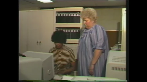 1980s: supervisor logging onto computer for authorized person Video stock 129853021