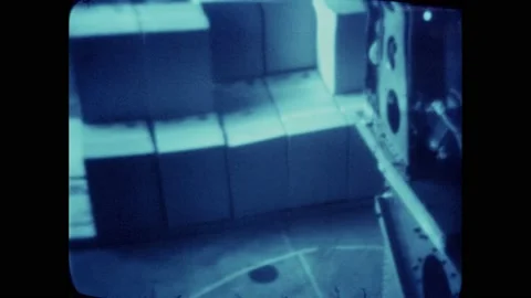 1980s: Tall stack of boxes slowly moves towards robot. Front part of robot spins Stock Footage 174735002