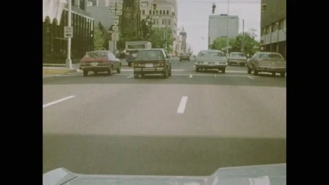 1980s: Traffic on road. Cars driving on city streets. Face of person. Cars on Stock Footage 169948064