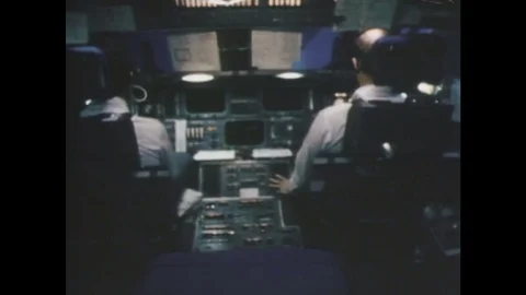 1980s: UNITED STATES: Commander inside space shuttle. Pilot flies shuttle. View Stock Footage 84615776
