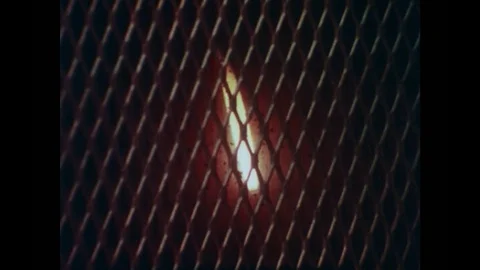 1980s: View of flame through screen. Man on computer in lab. Close up of Video stock 83129953