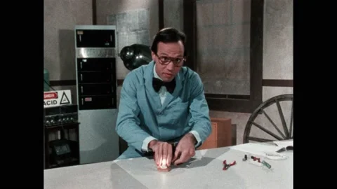 1980s:Rain clouds in the sky. Man in lab coat works at desk in laboratory. Light Video stock 220380134