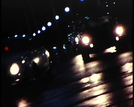 1981: Headlights / Shadows /  Melbourne City at Night   Stock Footage 46490086