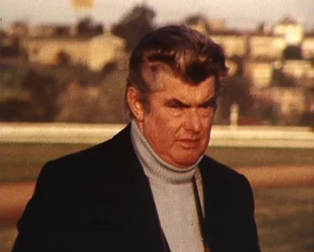 (1982) Bart Cummings (Horse Trainer) at racetrack prior to Melbourne Cup  Stock Footage 61378388