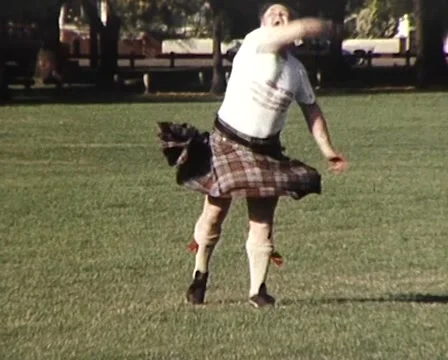 1982: Scottish Man in Kilt Throws Ball and (Flashes Camera) Stock Footage 59997026