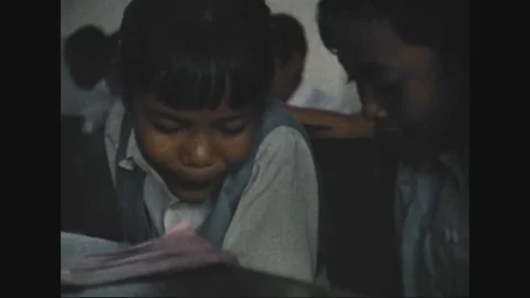 1982 - A teacher explains the different languages used by her students in Stock Footage 126061474