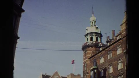 1982:DENMARK. Flag On Top Of Building Blows In The Wind Against A Blue Sky Fotos de archivo