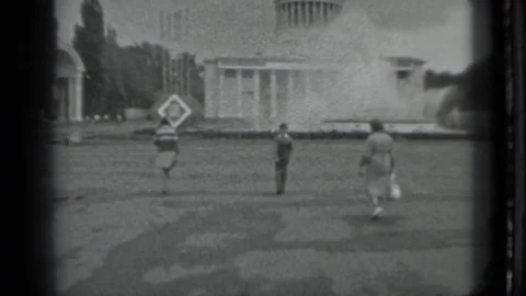 1983: Three People Walking Toward Building Holding Objects Stock Footage 72730700