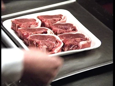 1988: Beef Being Packaged in Plastic For Supermarket or Butchers Stock Footage 84840540
